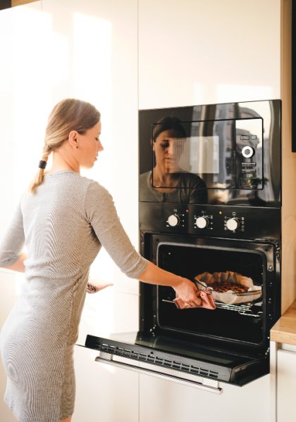 woman-taking-freshly-baked-jem-pie-out-of-oven-2023-11-27-05-04-46-utc (1)